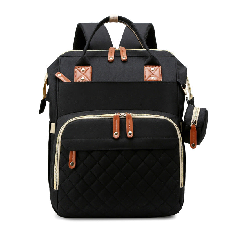 Stylish travel diaper bag converts to a secure portable baby bed. Essential baby gear for trips.