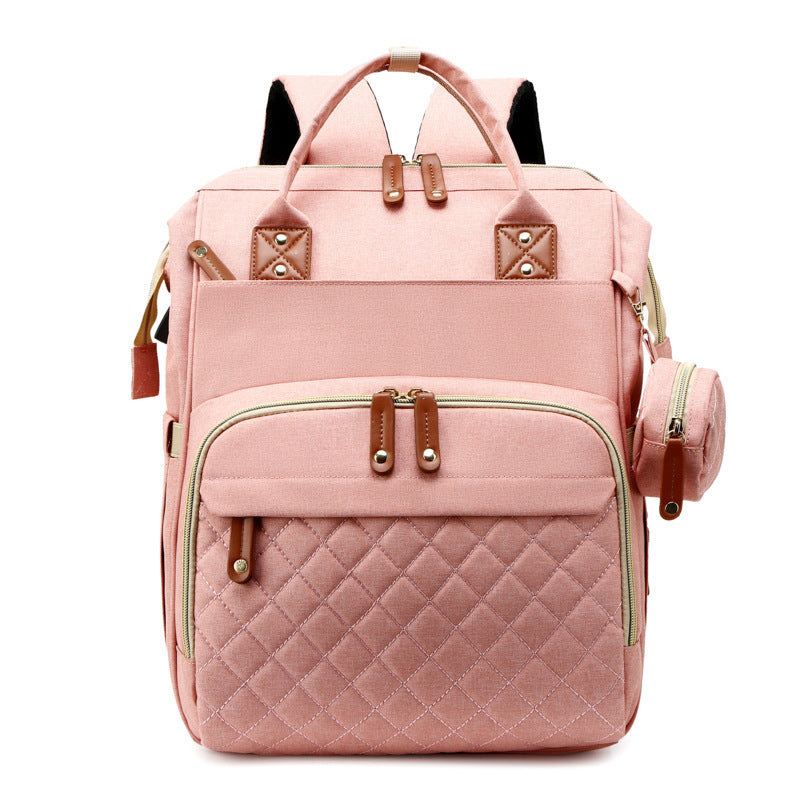 Convenient diaper bag with a pop-out portable baby bed, making travel with baby easier.