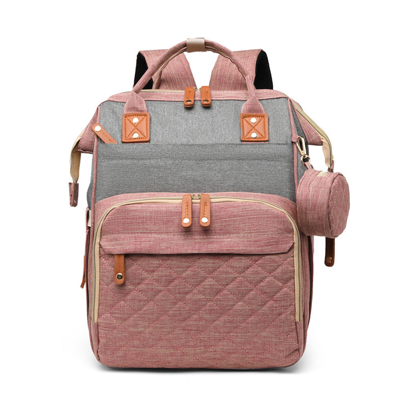 Compact travel diaper bag for baby with a built-in foldable bed. Practical baby accessories.