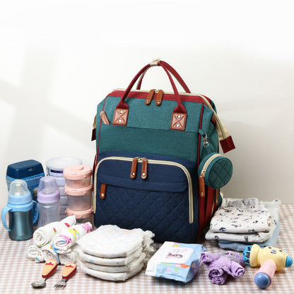 Grey travel diaper bag, easily converts into a portable baby bed. Must-have for active parents.