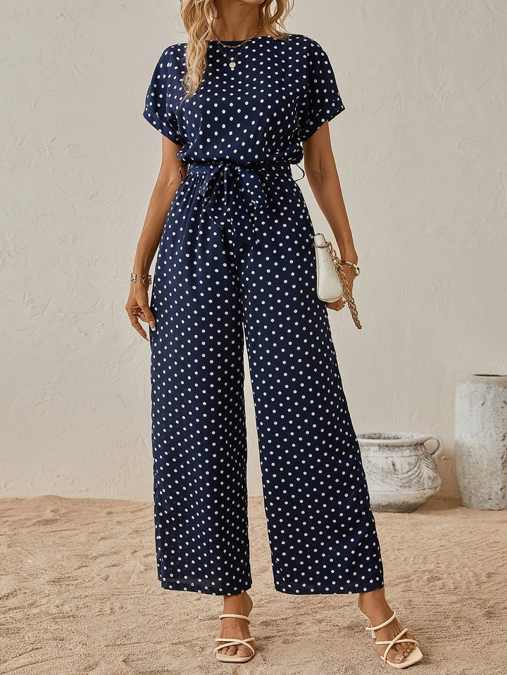 Stylish women's polka dot short sleeve jumpsuit with elastic waist. Ideal one-piece summer outfit.