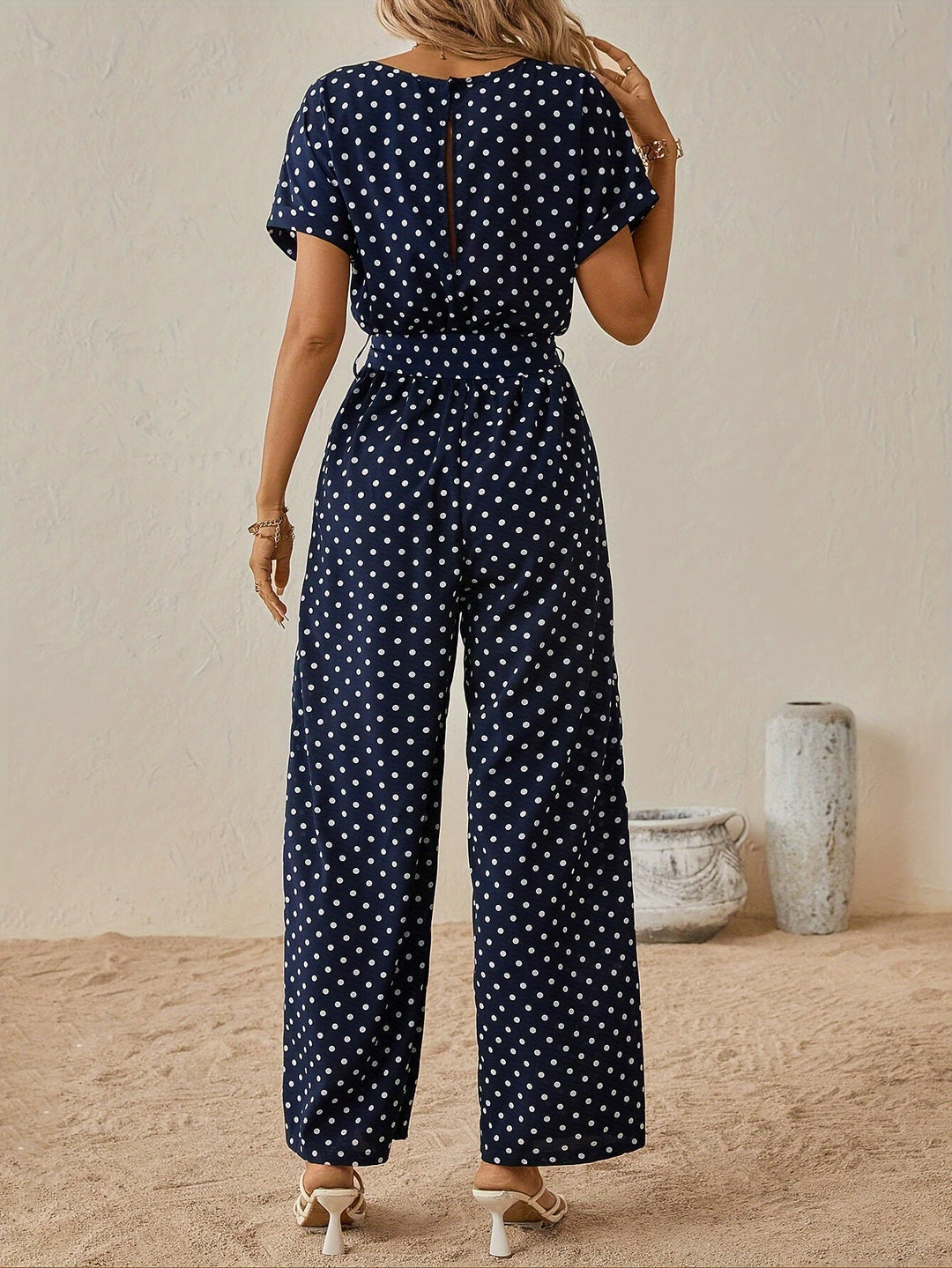Chic women's polka dot jumpsuit with flattering waistband. A trendy one-piece for summer outfits & travel.