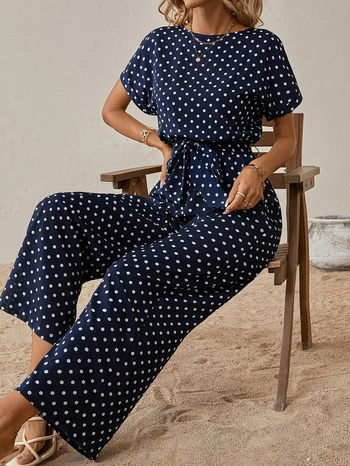 Fashionable women's polka dot one-piece jumpsuit with waistband, perfect for trendy summer vacation style.