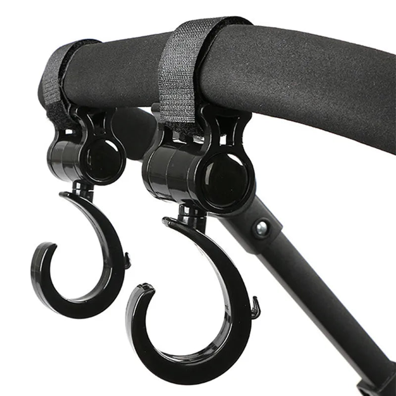 Two black multi-purpose stroller hooks for hanging diaper bags, groceries & more, hands-free.