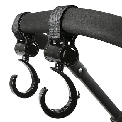Two black multi-purpose stroller hooks for hanging diaper bags, groceries & more, hands-free.