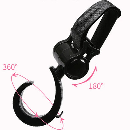 Close-up of a black multi-purpose stroller hook securely attached to a stroller handle.