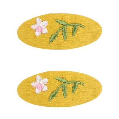 Side view of the retro floral hair clip, highlighting its secure and gentle clasp