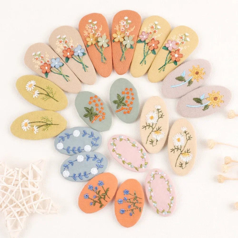 Close-up of a pink retro floral hair clip with a classic design for young girls' hair