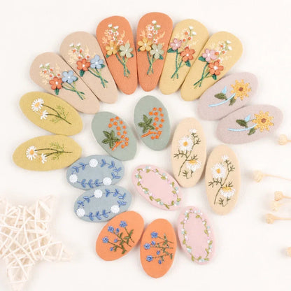 Close-up of a pink retro floral hair clip with a classic design for young girls' hair