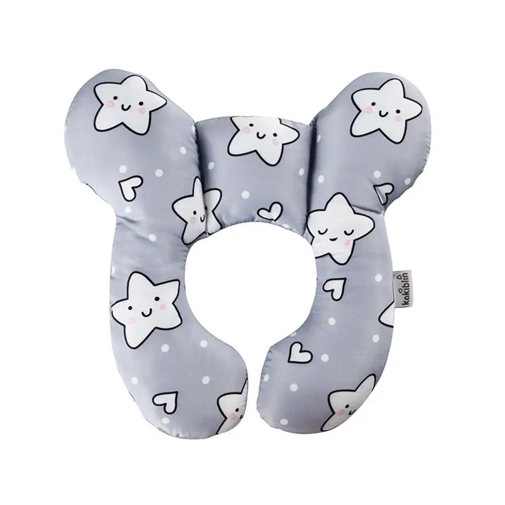 Close-up of a baby's head nestled comfortably in a U-shaped neck support pillow while in a stroller, ensuring stability