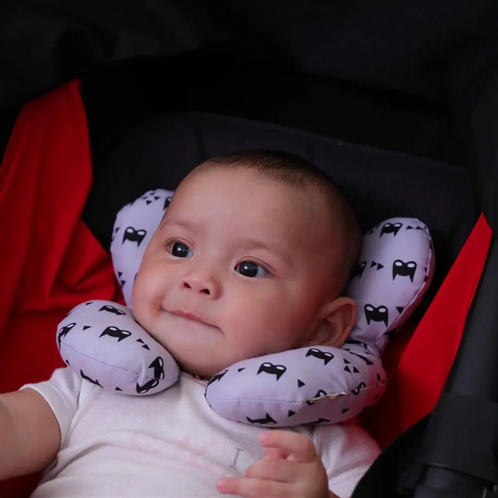 Packaged U-shaped baby neck support pillow, ready for travel or use in a stroller, ensuring infant comfort