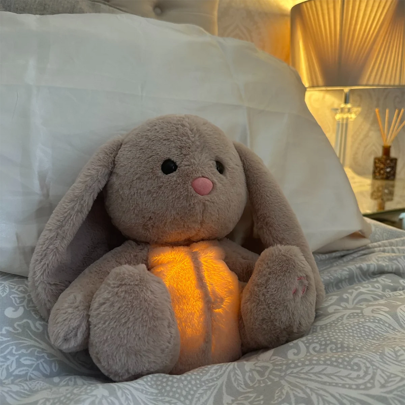 Calming cuddle toy plush resting on a bed, ready to provide relaxation & stress relief after a long day.