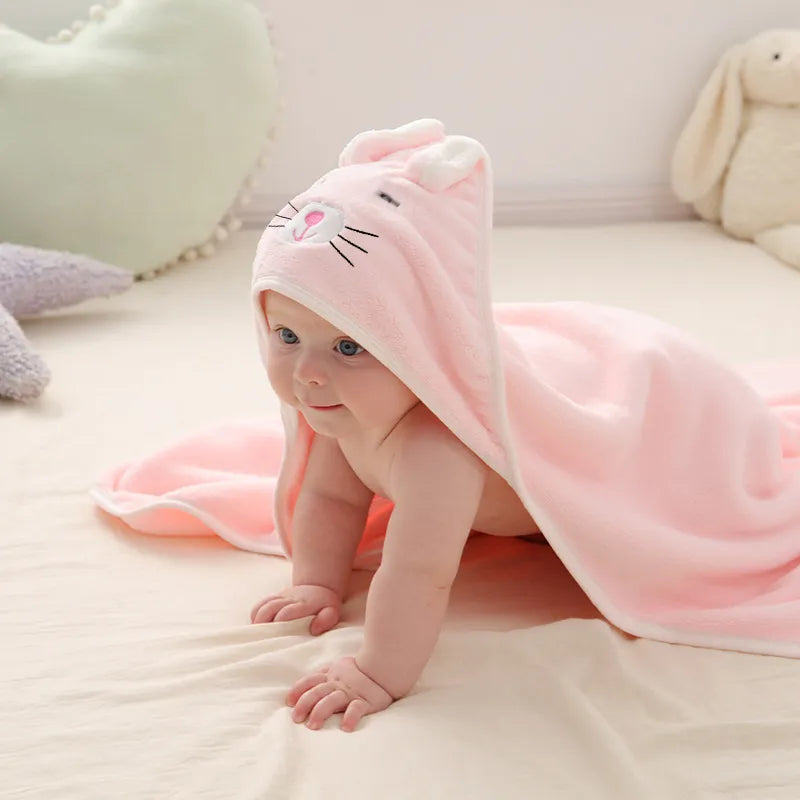 Plush coral fleece baby blanket with hood, ideal for wrapping toddlers after a bath.
