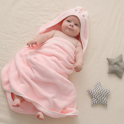 Gentle coral fleece hooded towel for babies, ensuring warmth and comfort post-bath.