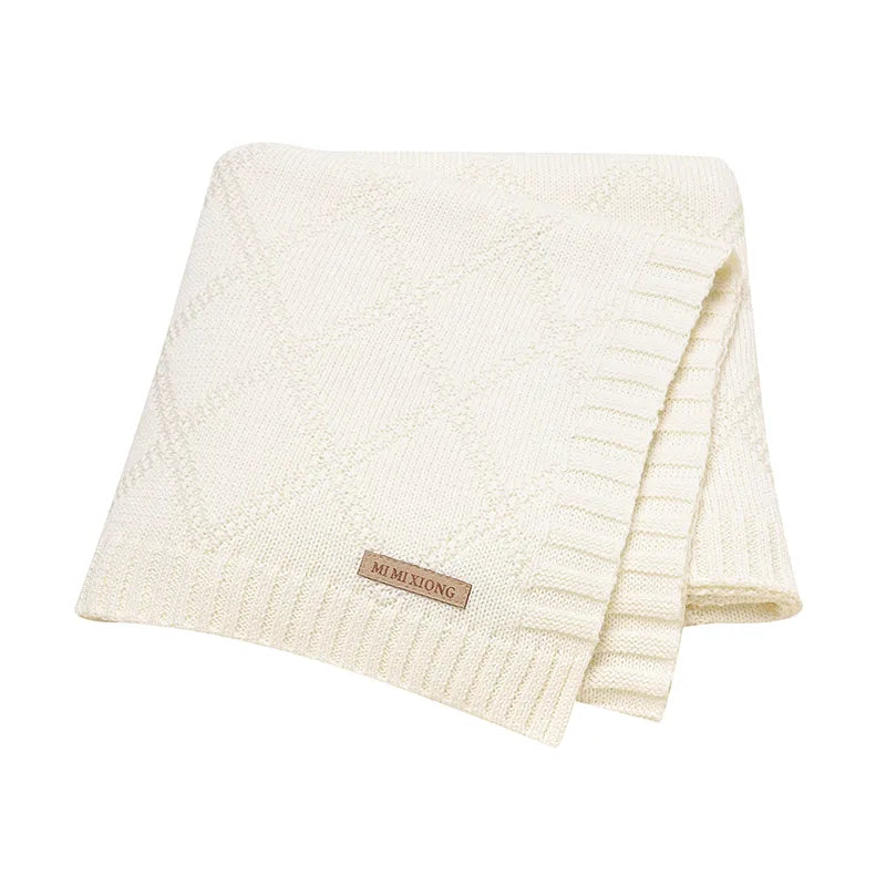 Detail of the fine weave on a premium cotton baby swaddle blanket, highlighting its ultra-soft texture