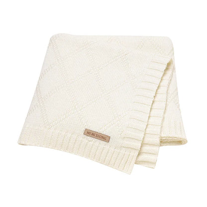 Detail of the fine weave on a premium cotton baby swaddle blanket, highlighting its ultra-soft texture