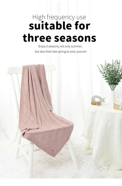 Large, breathable cotton swaddle blanket spread out, showcasing its generous size for newborns