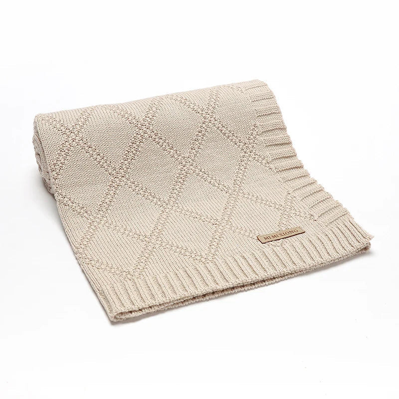 Close-up of a white textured cotton swaddle blanket, ideal for infant comfort and safe sleep