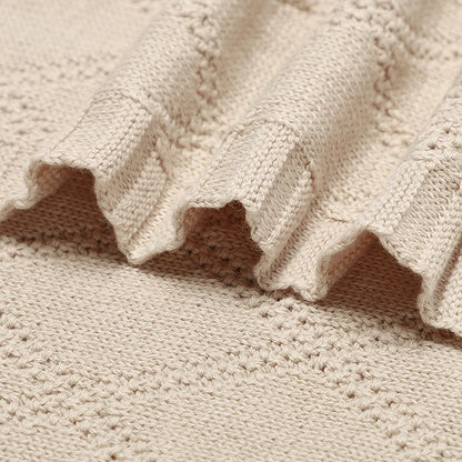 Newborn wrapped snugly in a breathable cotton swaddle blanket, promoting sleep and comfort
