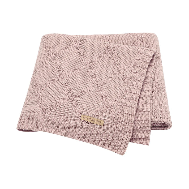Stack of folded cotton swaddle blankets in assorted pastel colors, great baby shower gift options