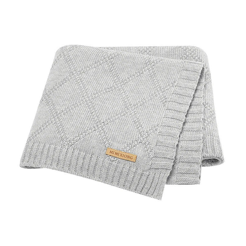 Mother holding a baby securely wrapped in a soft cotton swaddle, promoting bonding & comfort