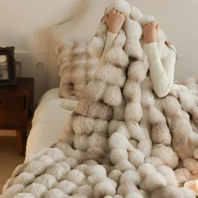 Portable faux fur throw blanket for travel or home. Ultra soft & warm, ideal for a cozy living room.