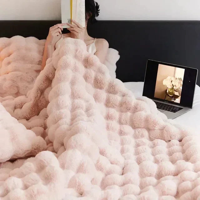 Warm & cozy faux fur throw blanket, perfect for snuggling. Portable beige/white design for home or travel.