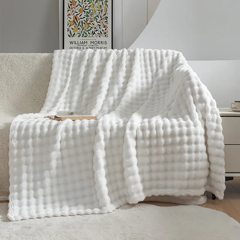 Plush flannel throw blanket in a cozy living room setting, ideal for snuggling and adding soft home decor.