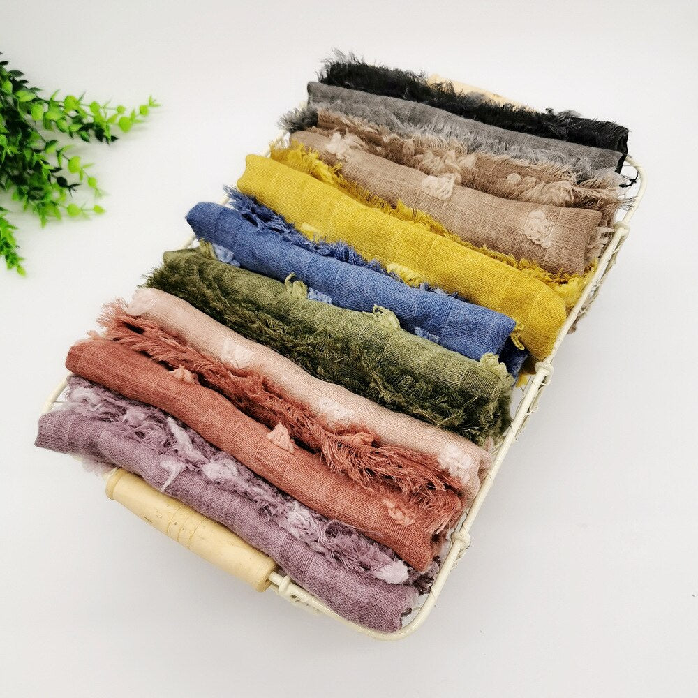 Neutral colored, ultra-soft infant swaddle blanket. Gentle cotton newborn wrap for secure, cozy baby sleep.