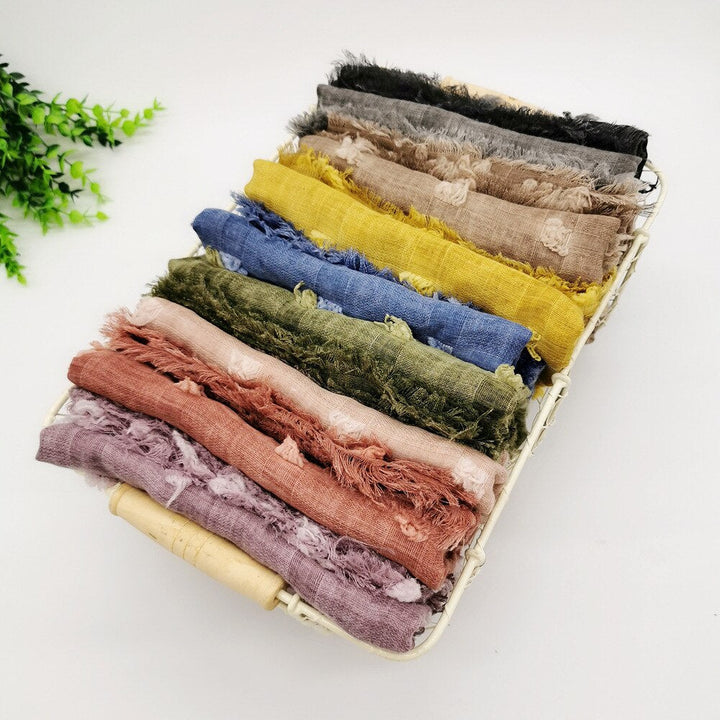Neutral colored, ultra-soft infant swaddle blanket. Gentle cotton newborn wrap for secure, cozy baby sleep.