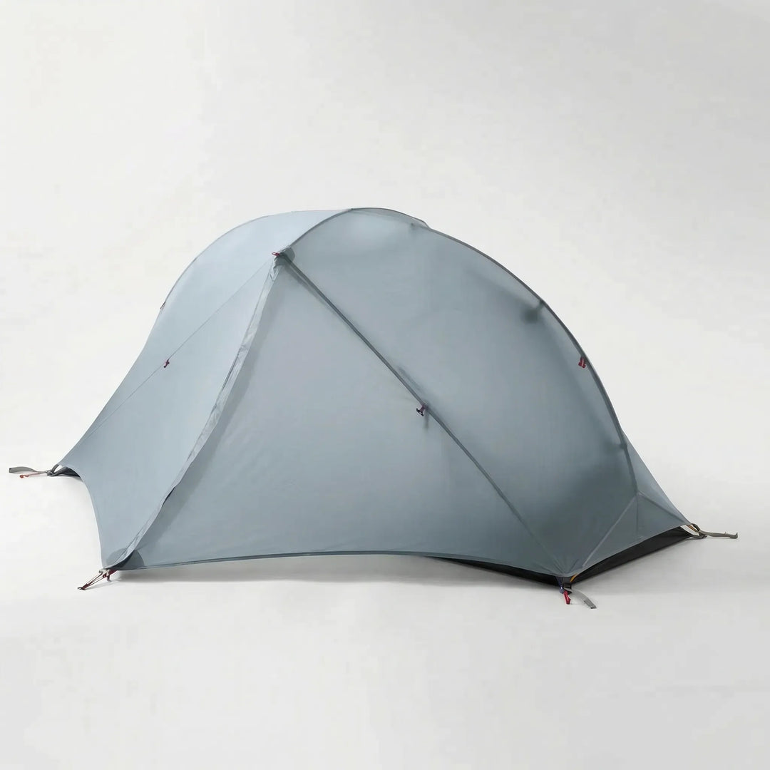 Unisex ultralight 1-person hiking tent setup in nature. Double-layer for 3-season or 4-season outdoor shelter.