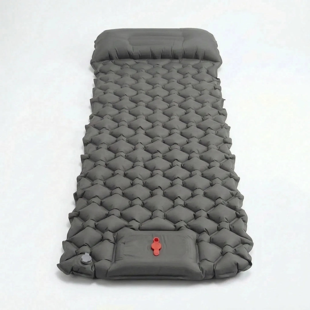 Quick-inflate ultralight sleeping pad, a portable camp bed with built-in pillow for outdoor recreation.