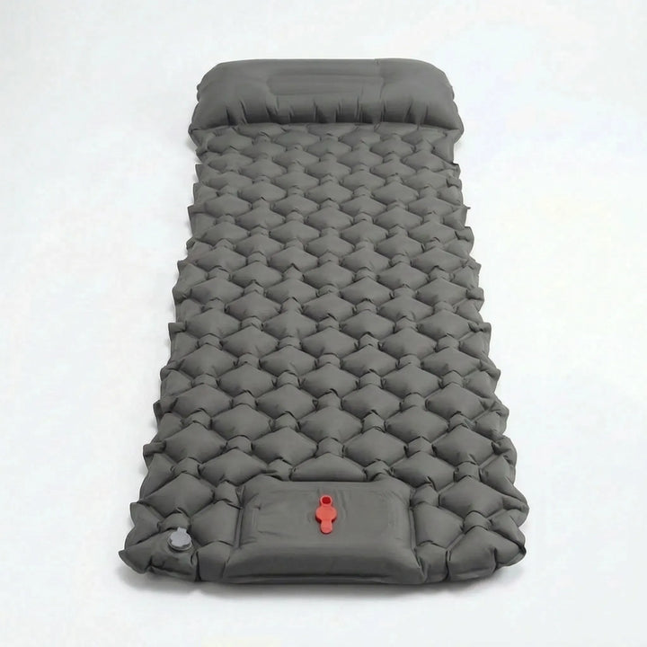 Quick-inflate ultralight sleeping pad, a portable camp bed with built-in pillow for outdoor recreation.