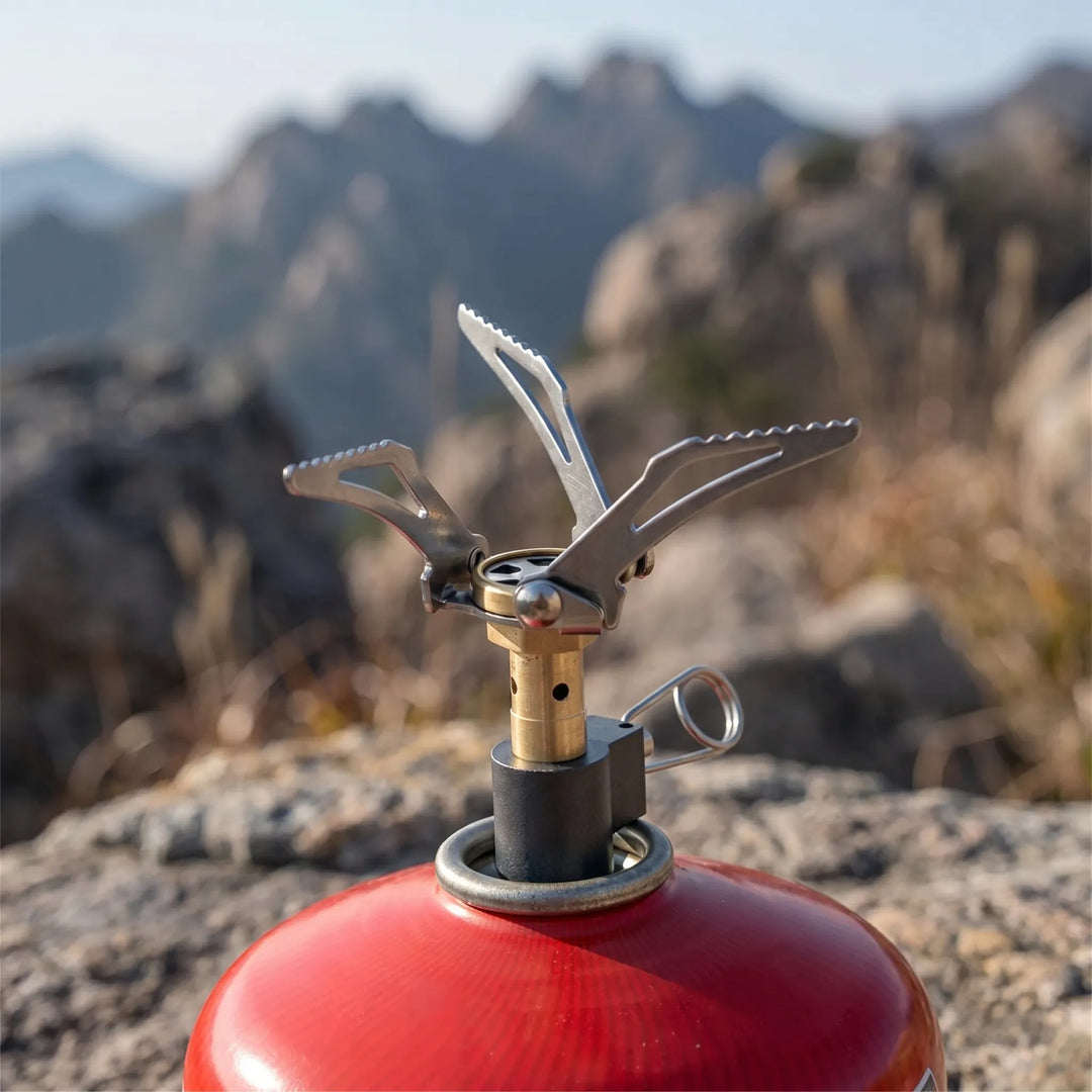 Ultralight folding camping gas burner for backpacking, hiking, and outdoor cooking.