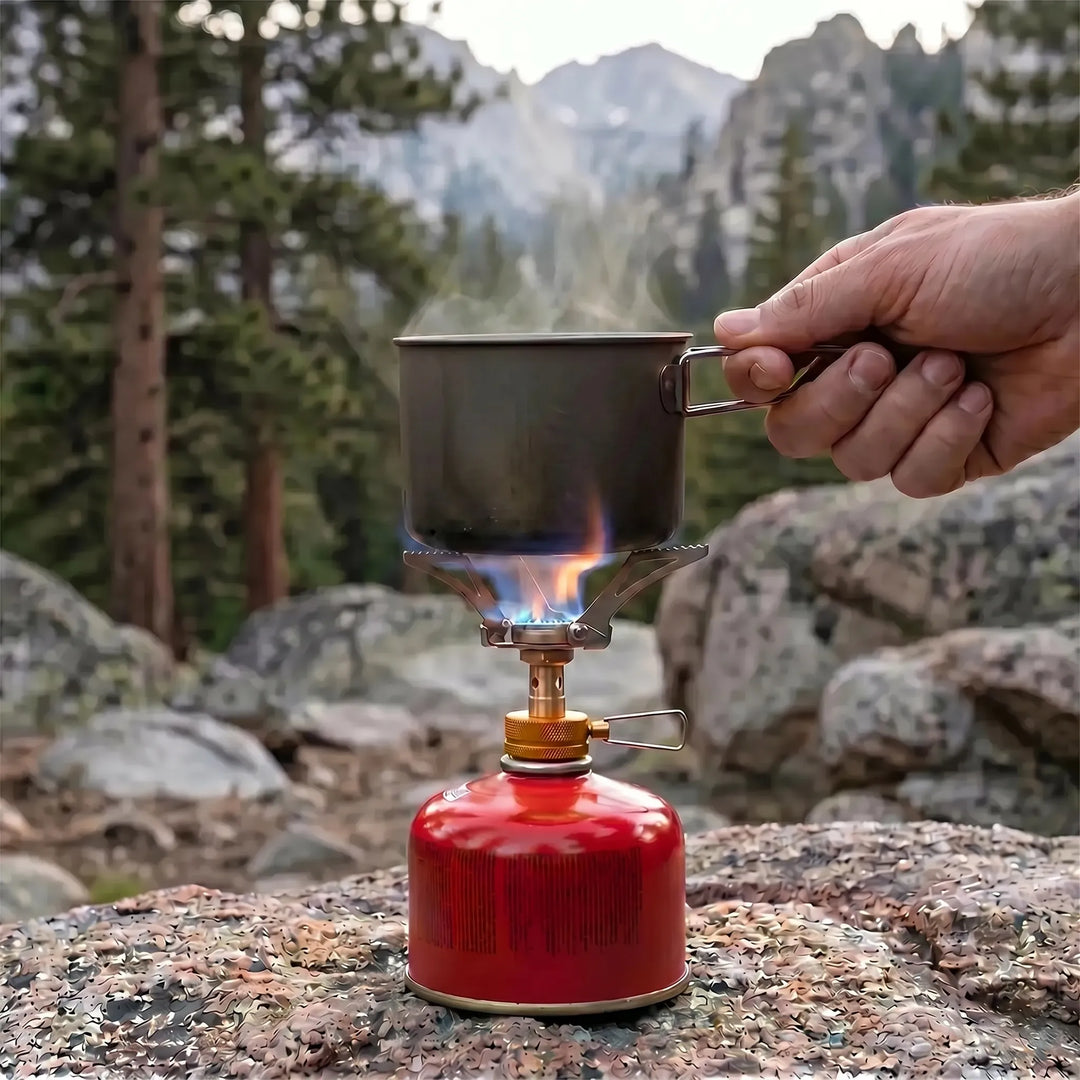 Close-up of a compact ultralight folding gas burner, ideal for camping, hiking, and outdoor cooking.