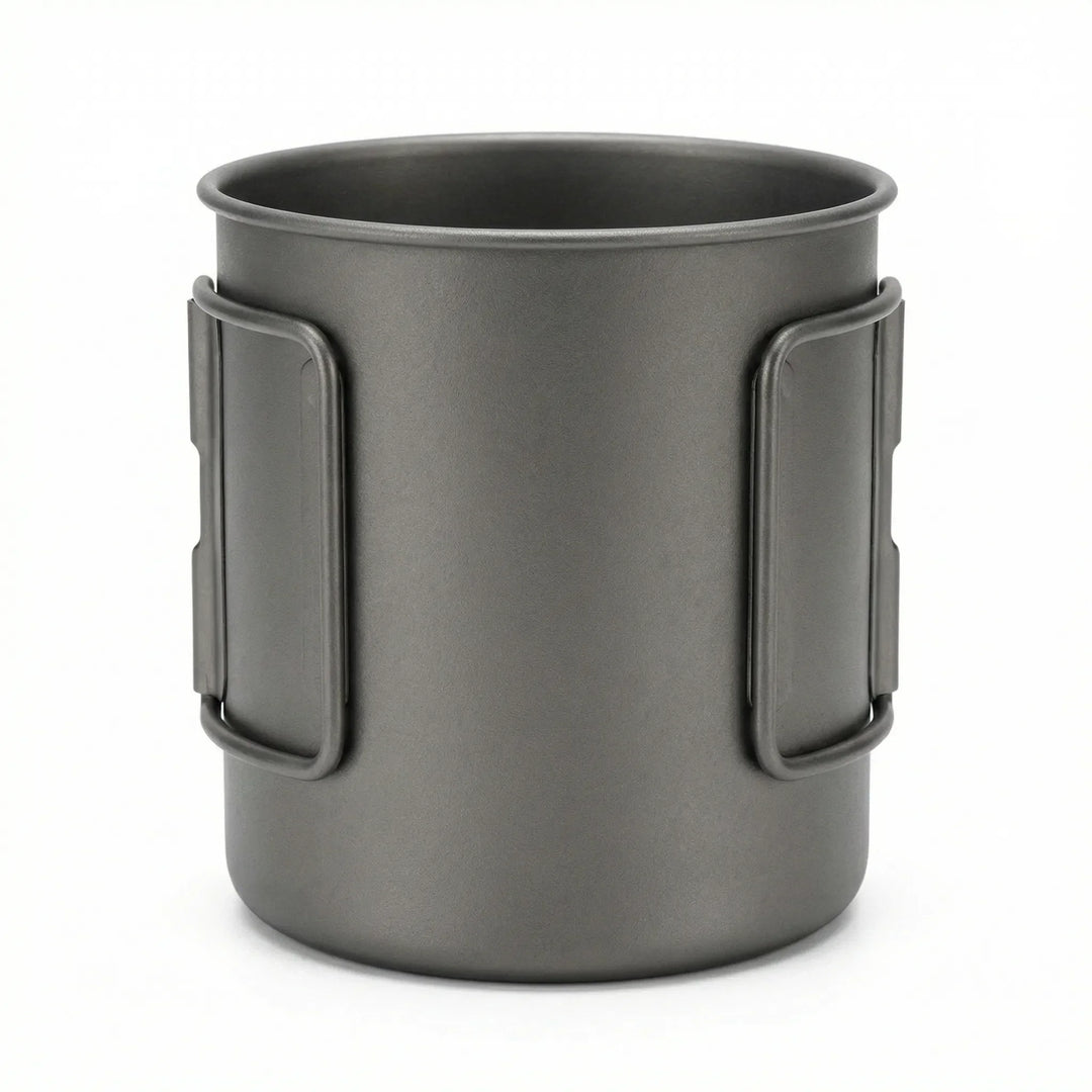 Lightweight titanium outdoor cup with a heat-resistant, foldable handle for camp kitchen.