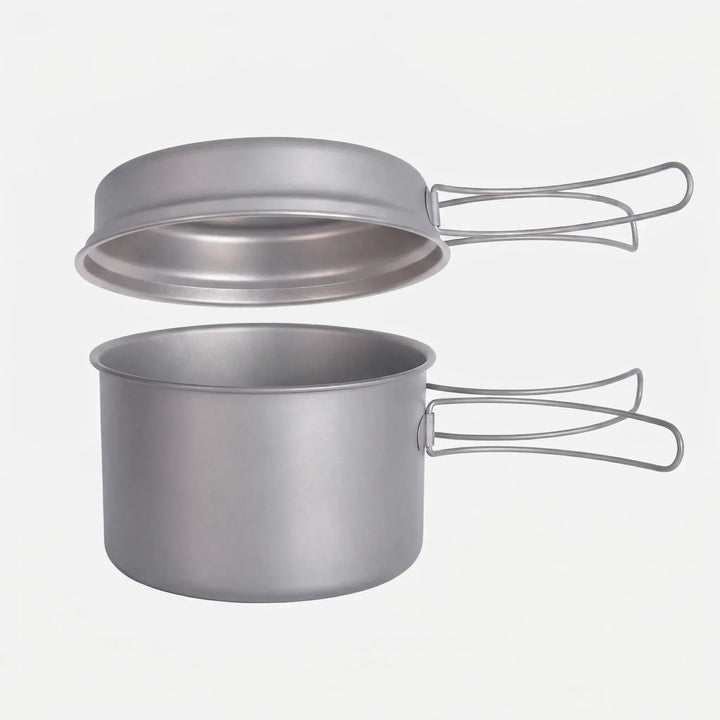 Essential titanium camping cookware set with folding handles, designed for ultralight outdoor cooking & backpacking.