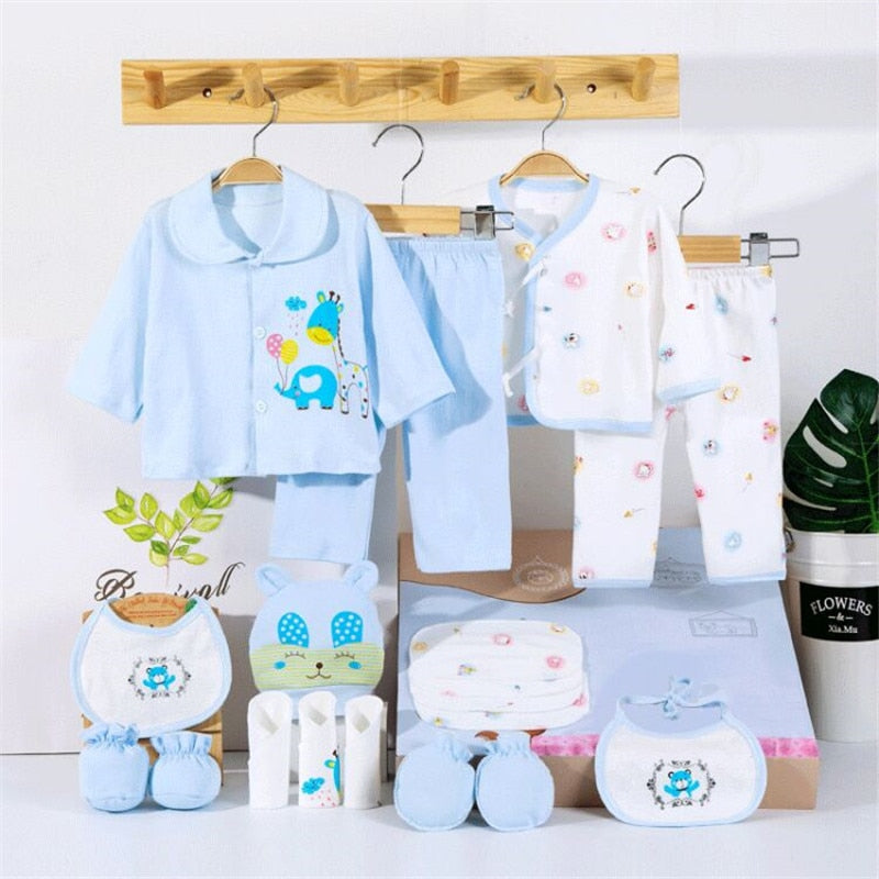 Close-up of soft cotton fabric and 'dinosaur' pattern print from a newborn baby clothing set (0-3M)