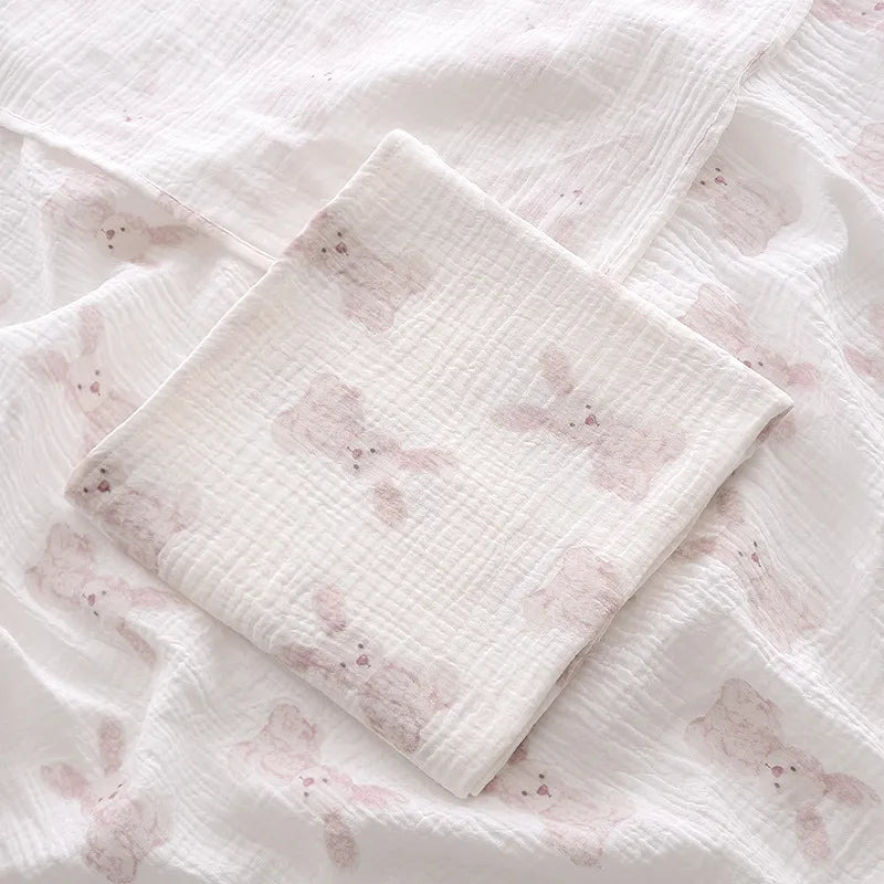 2-layer cotton muslin swaddle blanket spread out, showcasing its generous size for baby comfort
