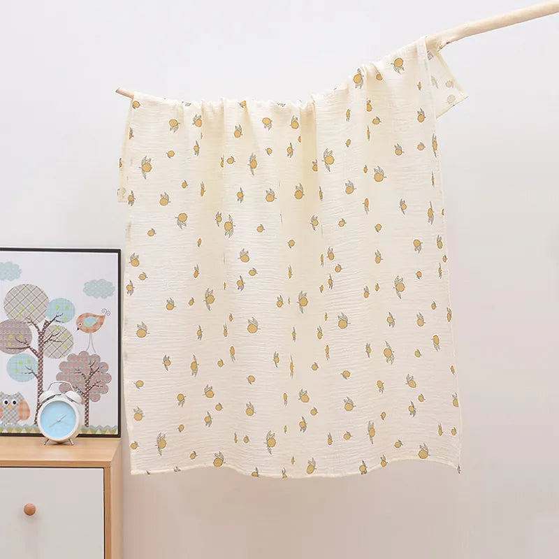Newborn baby wrapped snugly in a breathable 2-layer cotton muslin swaddle blanket, gentle on skin