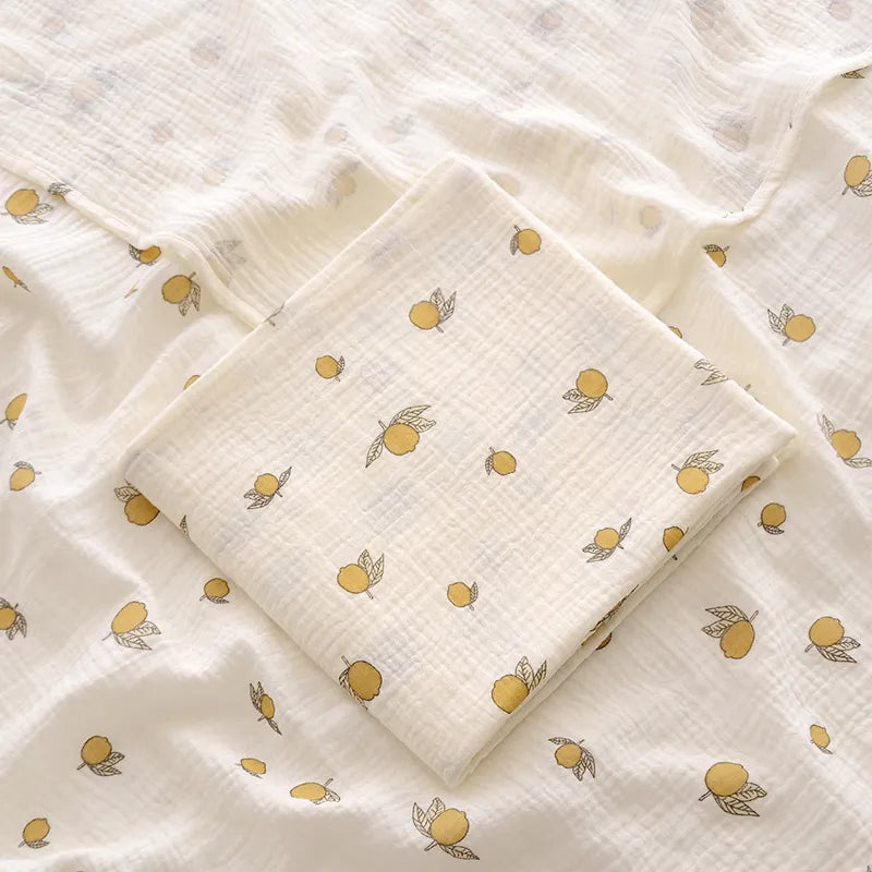 Close-up of the texture of a 2-layer cotton muslin swaddle blanket, showing its soft weave for infants