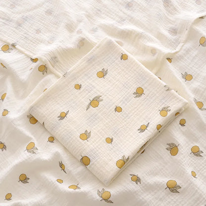 Close-up of the texture of a 2-layer cotton muslin swaddle blanket, showing its soft weave for infants