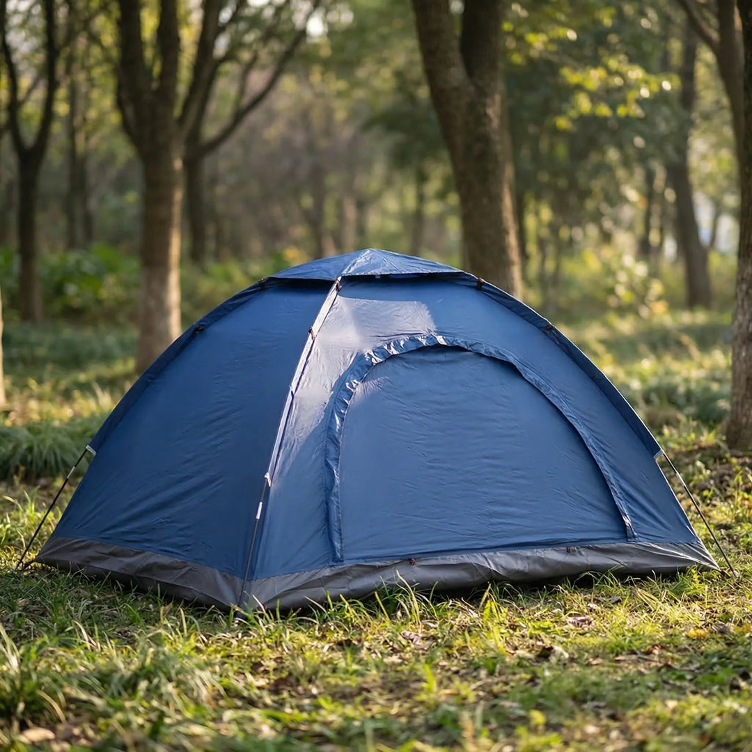 Unisex 2-person portable camping tent set up in a forest clearing, highlighting its quick setup and outdoor readiness.
