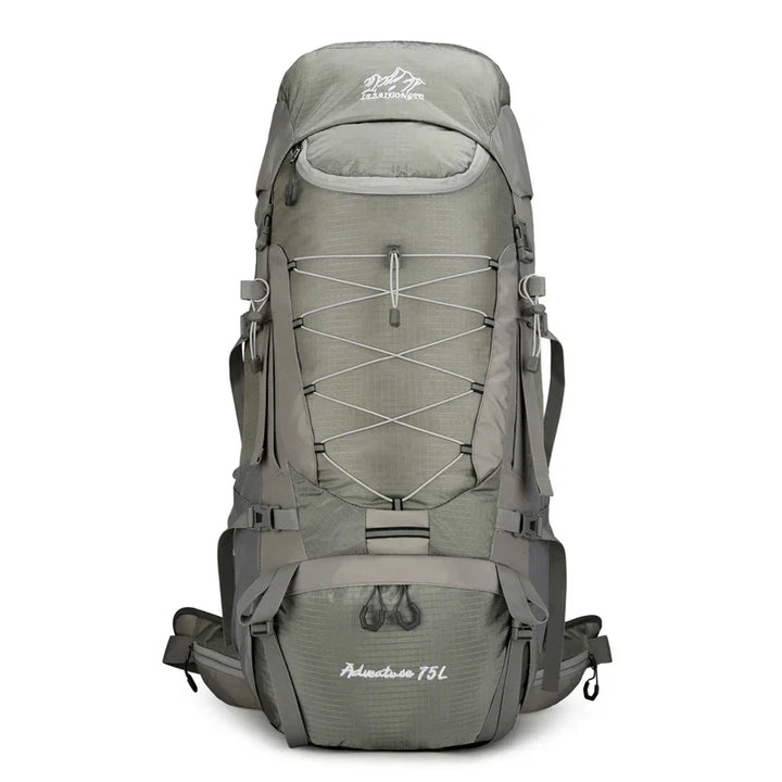20 Gallon unisex expedition backpack propped on rocks, perfect gear for a challenging outdoor adventure hike.