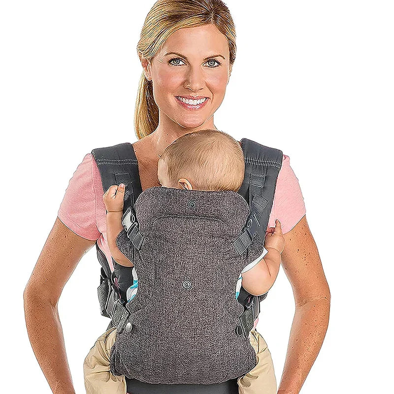 Happy baby looking out from the gray ergonomic front-facing carrier, ensuring comfort and view.