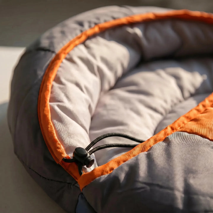 Lightweight envelope sleeping bag perfectly set up in a tent, ready for a comfortable 4-season camping trip.