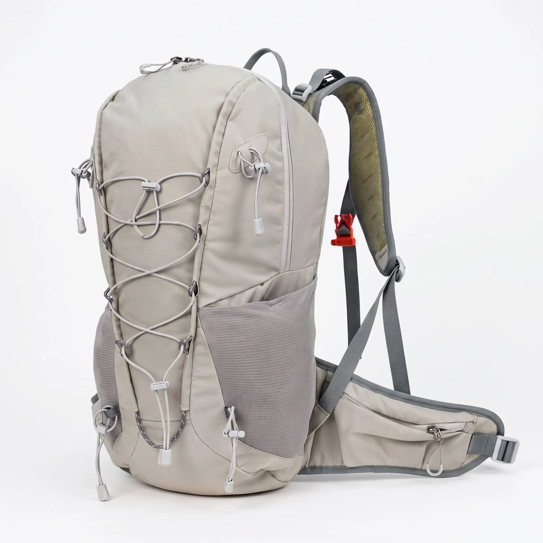 Hiker wearing a lightweight 6.6 gallon unisex outdoor daypack on a mountain trail adventure.