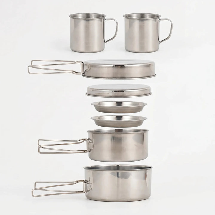 Hiker cooking a meal with the unisex compact camping cookware set & portable stove in a mountain camp.