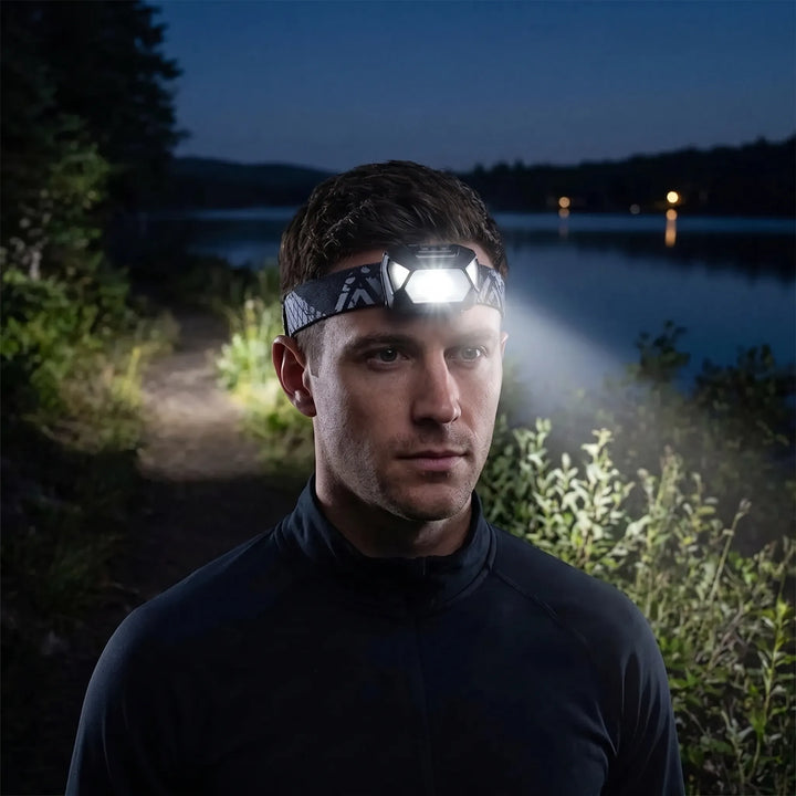 Unisex adjustable LED headlamp for hands-free outdoor activities, camping, and hiking. Bright, durable light.