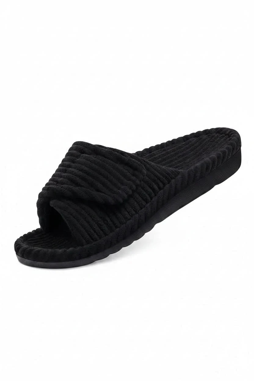 Unisex adjustable open toe comfort slippers by a couch, ideal for loungewear & all-day indoor relaxation.